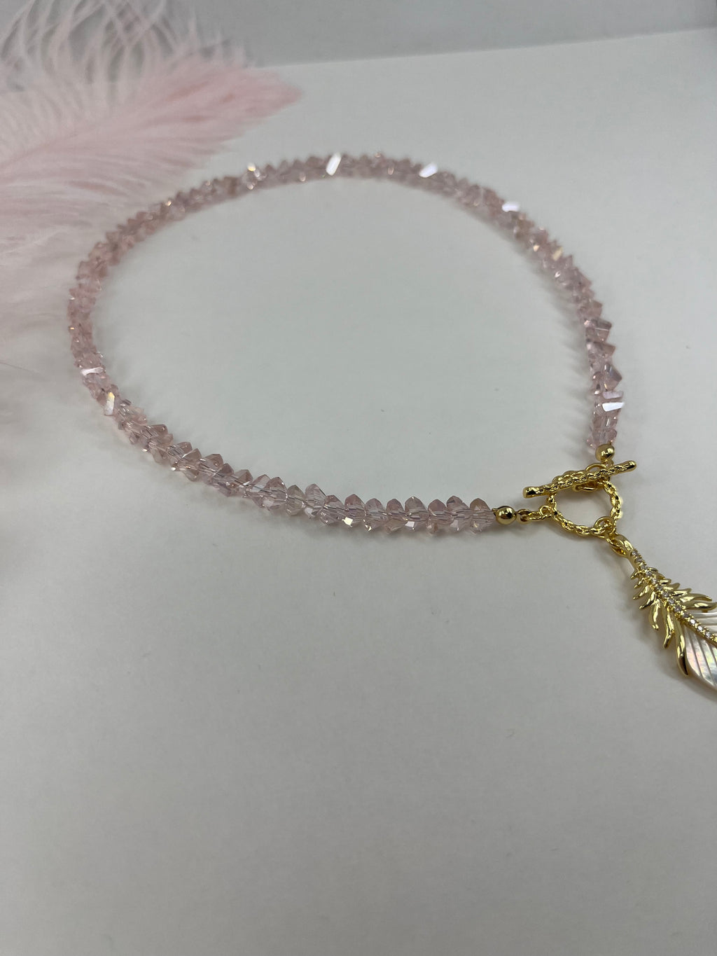 Pink crystal necklace with 14K gold Feather pendant