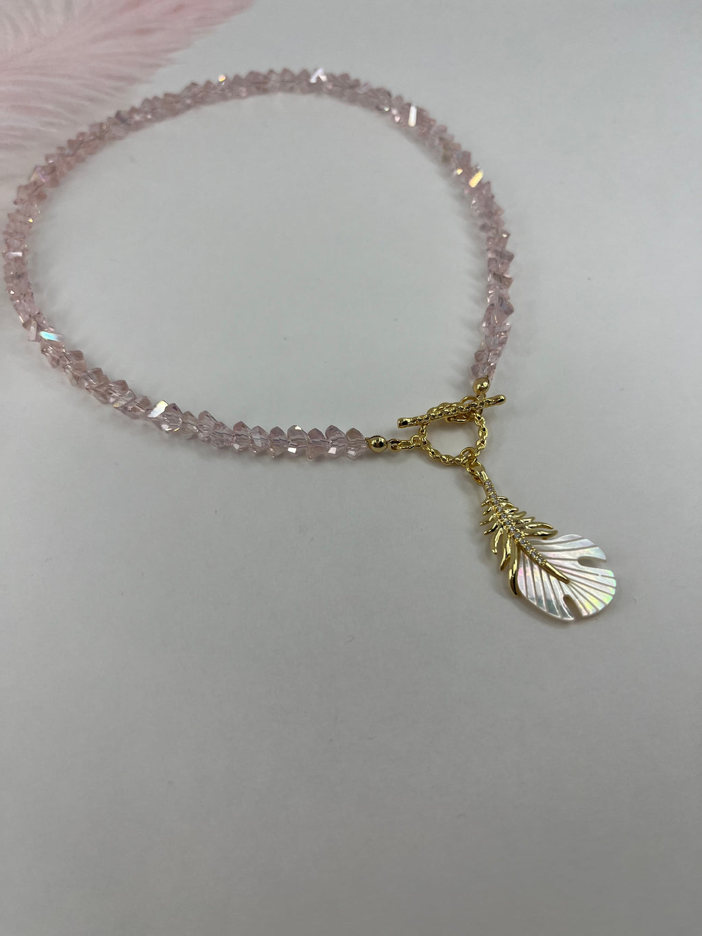 Pink crystal necklace with 14K gold Feather pendant