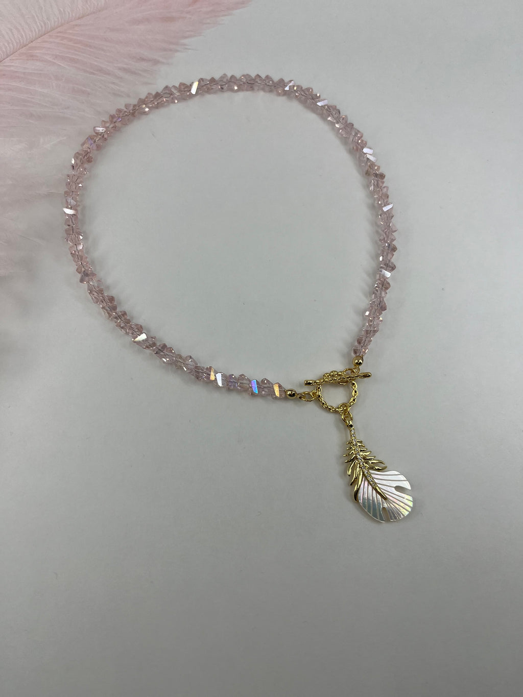 Pink crystal necklace with 14K gold Feather pendant